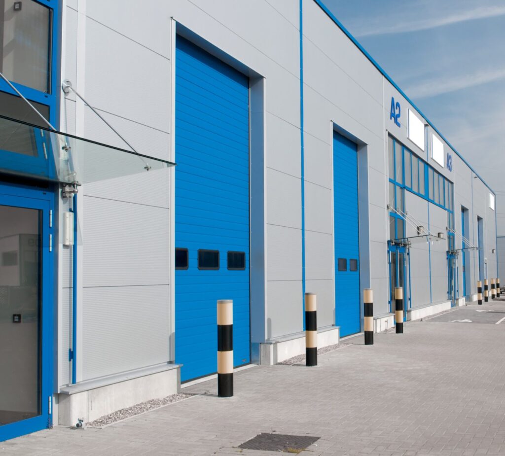 Industrial property exterior with loading bays and parking lot